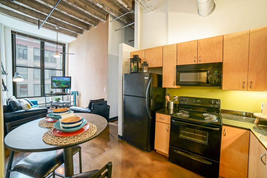 Kitchen and living room of a model apartment at Tailor Lofts