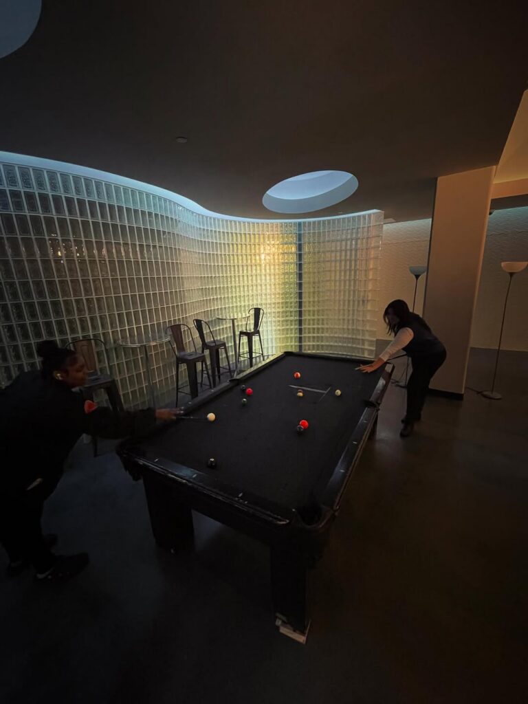 Tailor Lofts residents playing pool in the lounge